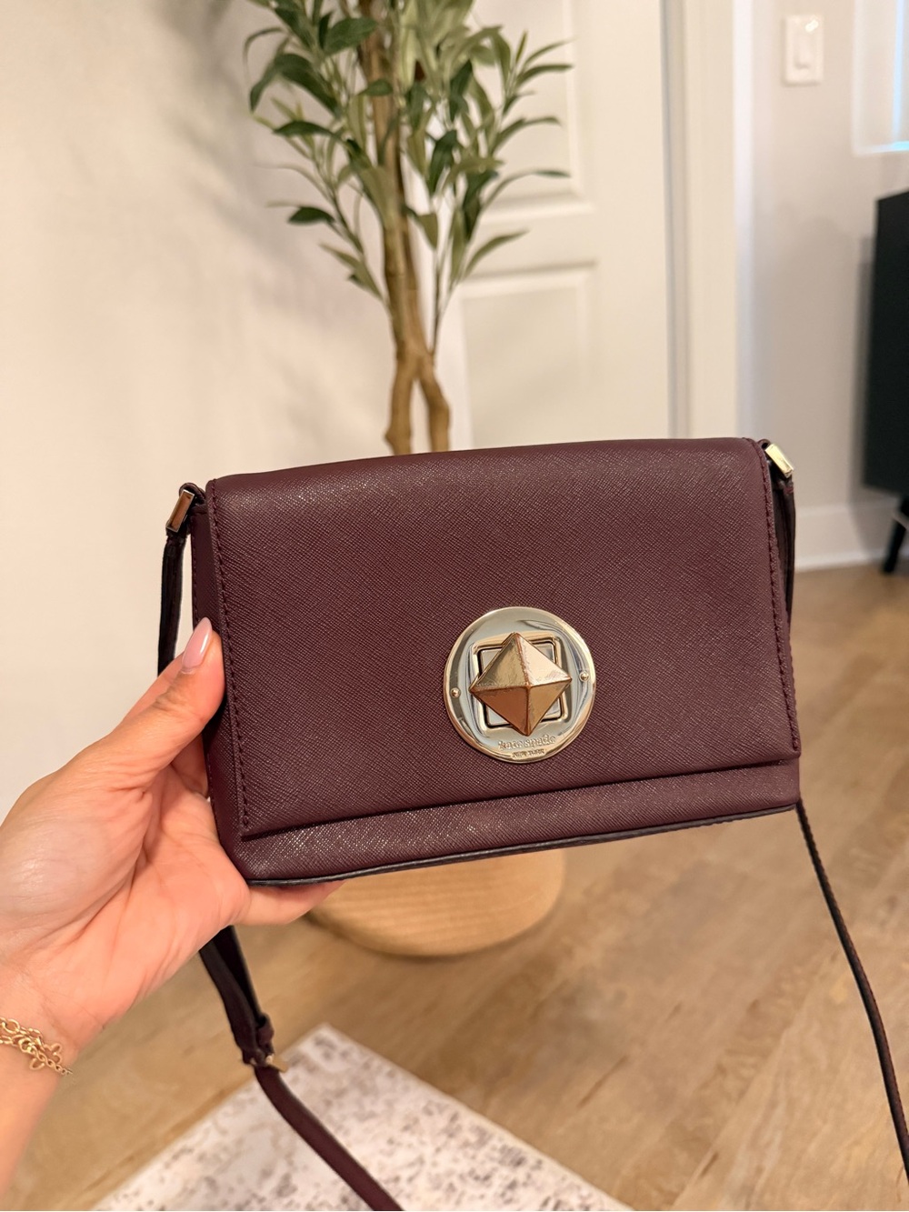 kate spade plum crossbody with gold-tone medallion